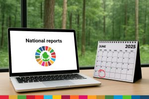 workspace with a laptop opened to the Global Forest Goals logo and a desk calendar with 30 June circled